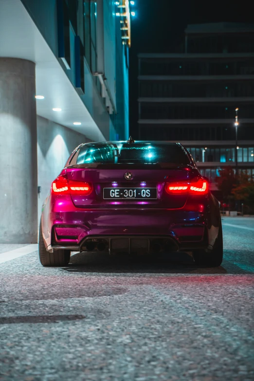 purple car parked in parking lot at night