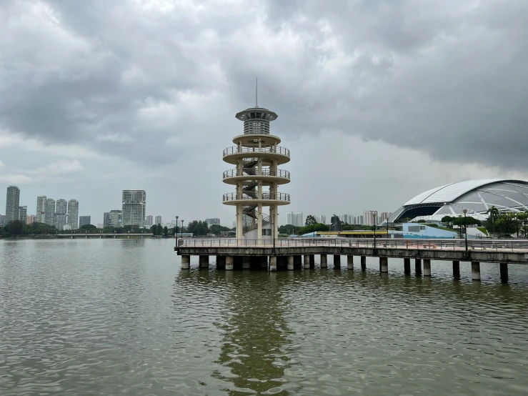 a tall white tower sitting above a large body of water