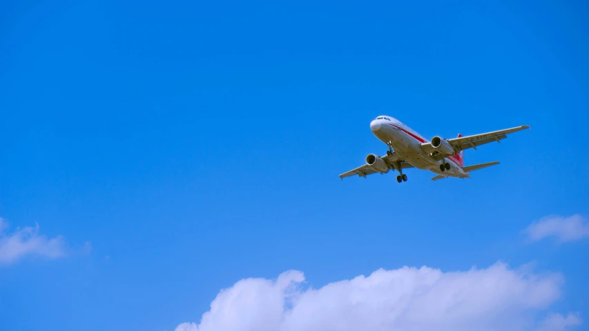 a large jetliner flying through a blue sky