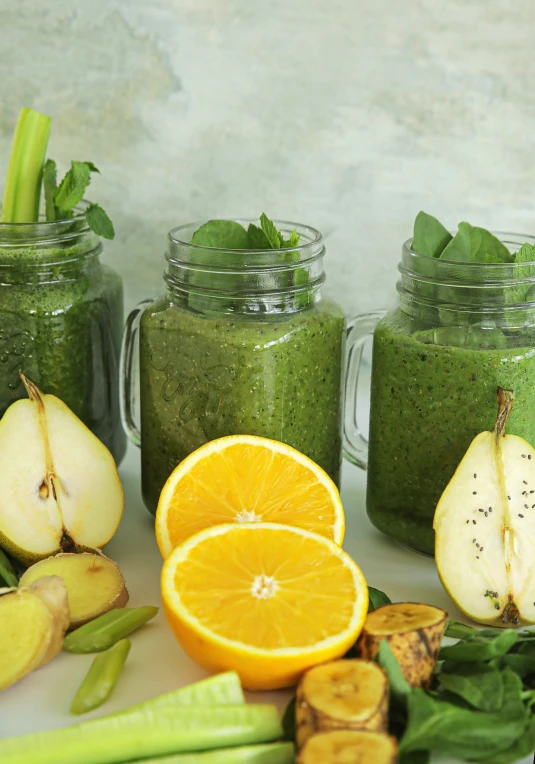 there are many green smoothie with fruits and vegetables