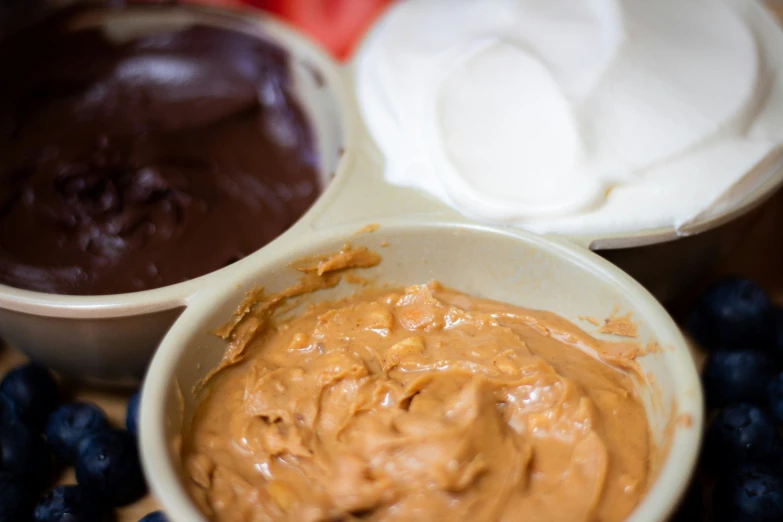 bowls of fruit with yogurt and chocolate in them