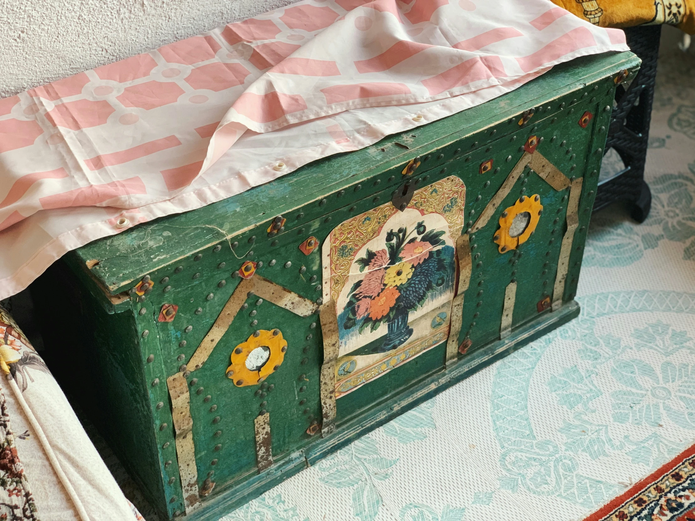 an old green wooden chest sitting in a room