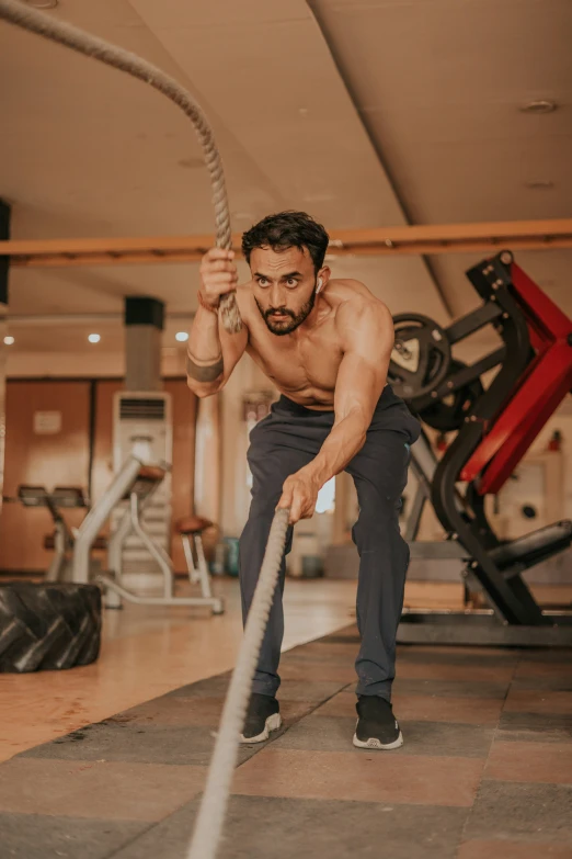 a man holding a metal bar in a gym