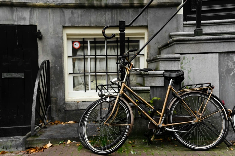 the old bicycle is locked to the building