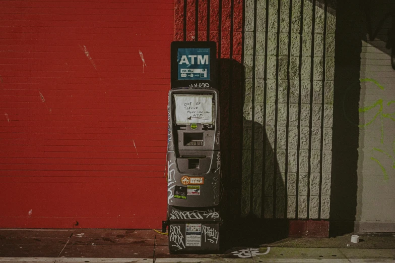 a street post sitting outside next to a red wall