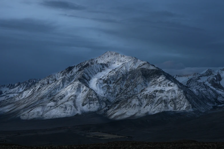 a mountain that is surrounded by snow and clouds