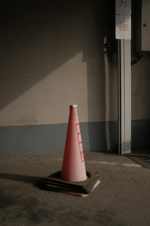 the street sign is next to a traffic cone