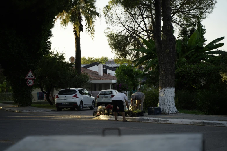 a person hing a stroller near some parked cars