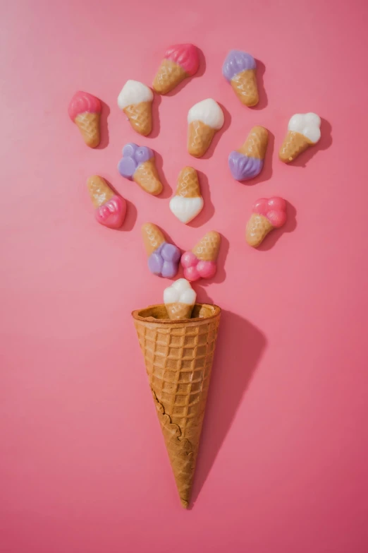 a cone is covered with marshmallows and candies