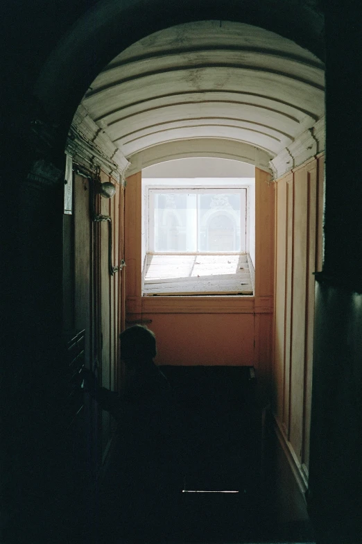 an interior view of a hallway with an arched door