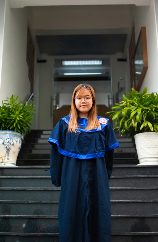 a woman standing in front of some steps and a set of stairs