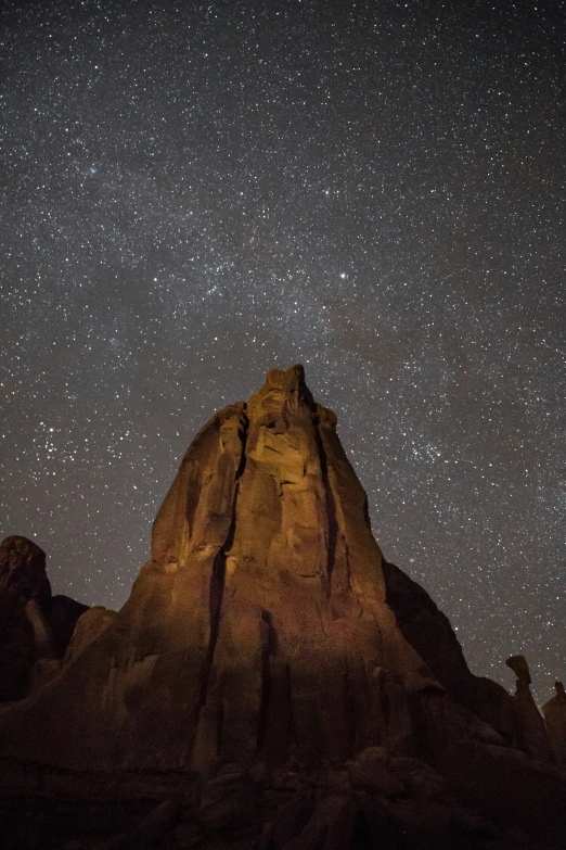 the stars above mountains and rocks at night