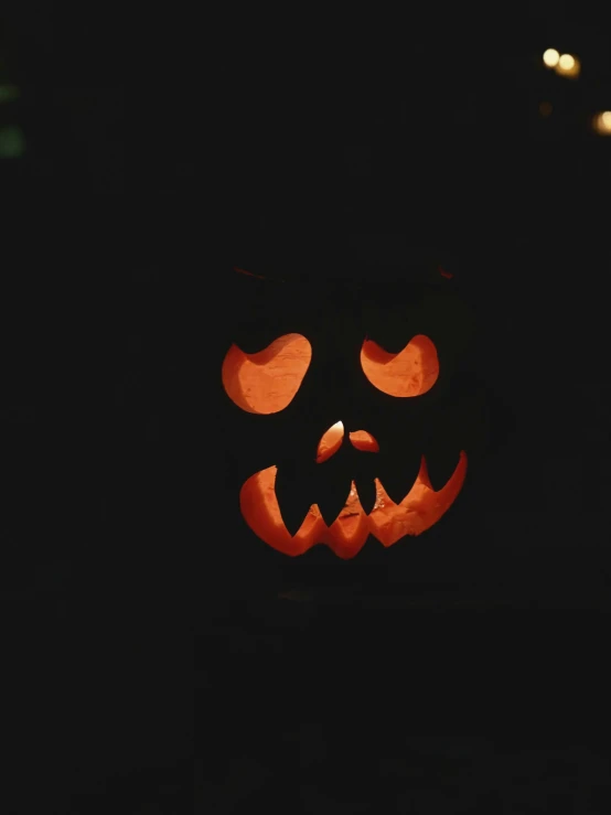 the pumpkin faces lit by lights that are glowing orange