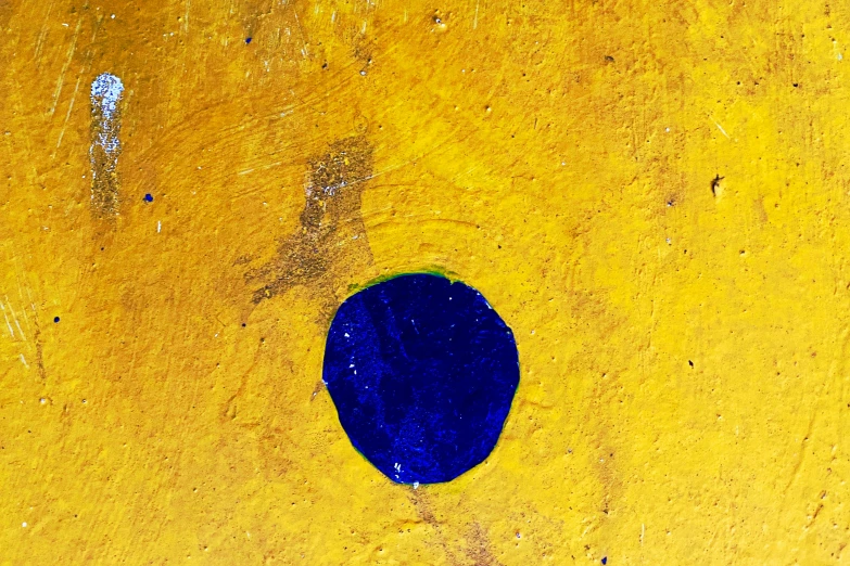 a blue object placed on a yellow surface