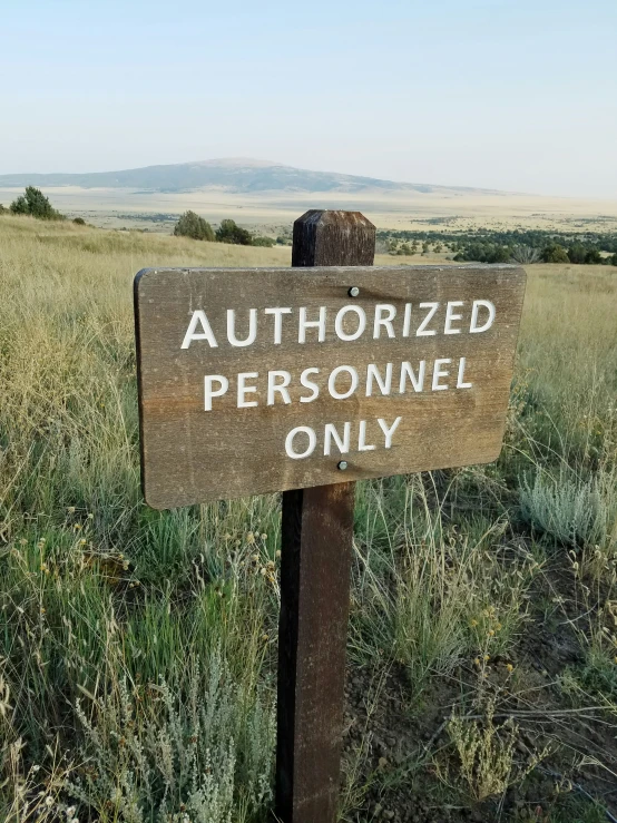 there is a sign in the middle of some grass