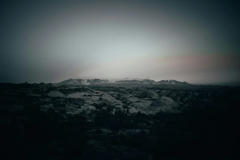 black and white pograph of sunbeams and mountains