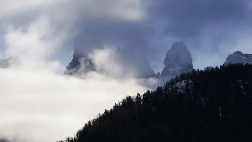 the mountain in front of it is dark and foggy