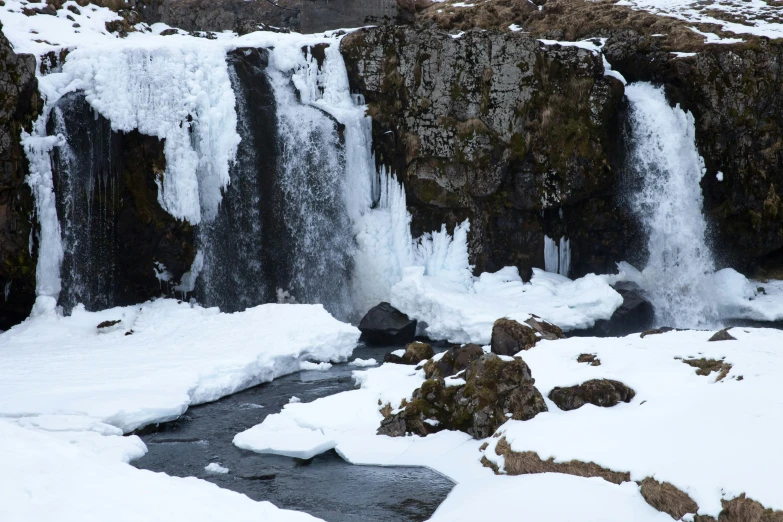 a couple of large waterfalls covered in snow