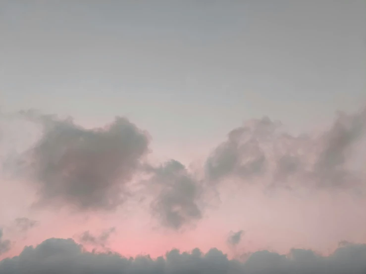 some very pretty pink clouds with a jet