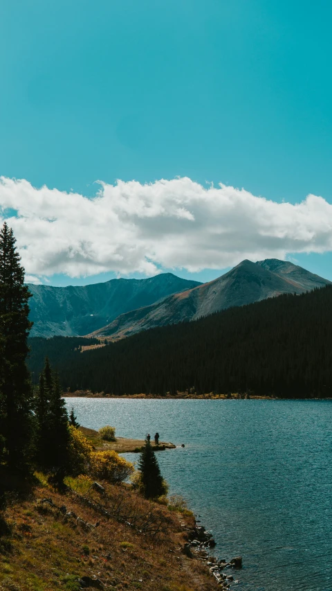 a body of water surrounded by mountains and trees