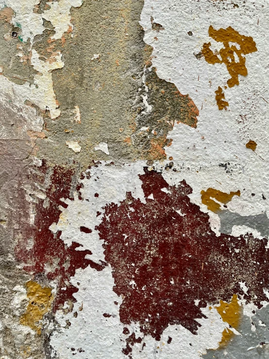 peeling paint is chipping through a wall