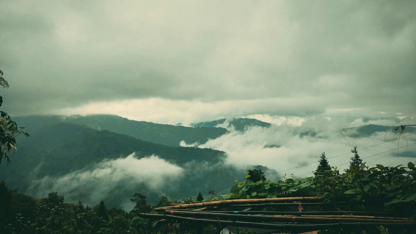 a scenic scene, in the foreground is the mountains and clouds