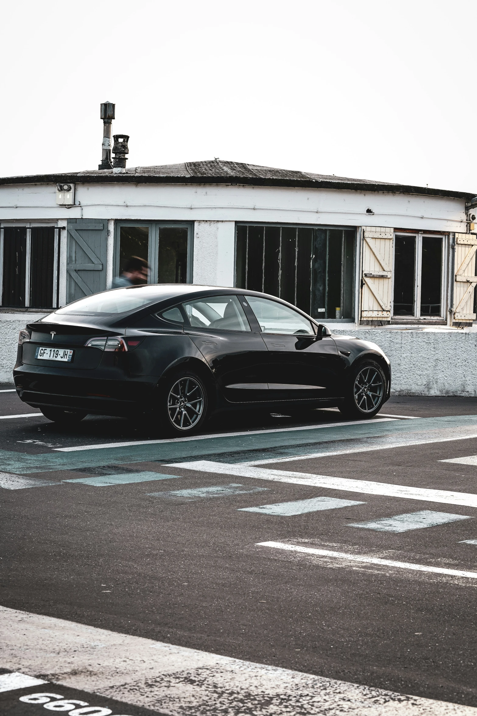 a black sporty looking car parked in front of a building