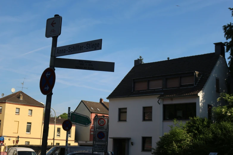 a house with a number plate next to some street signs