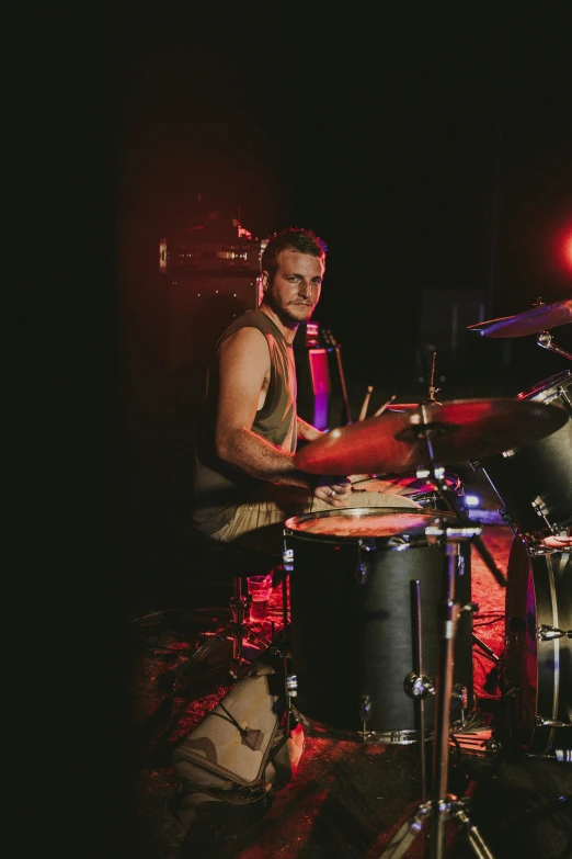 a drummer smiles while drumming his drums