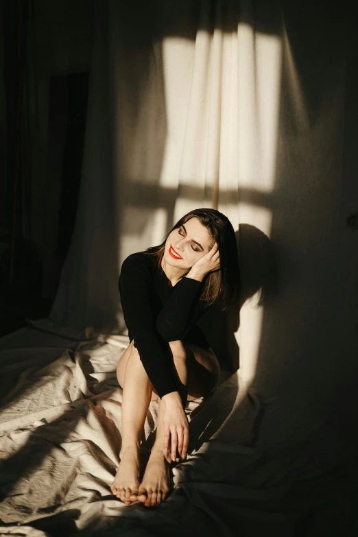 a girl poses for a po on her bed