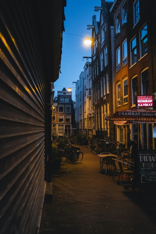 city alley with many benches at night time