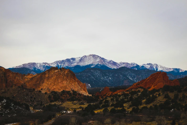 mountains in the background during the day with trees in foreground