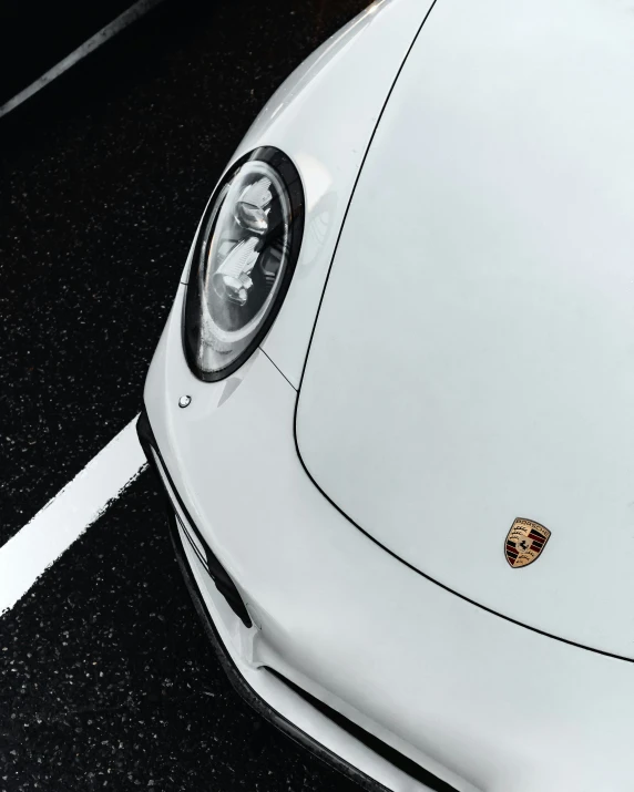 a close up view of a white car's hood