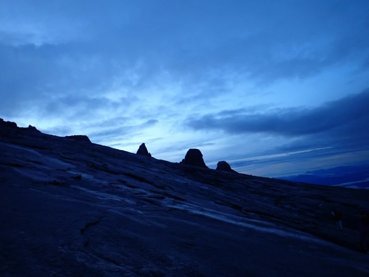 a group of people in silhouette on a hill