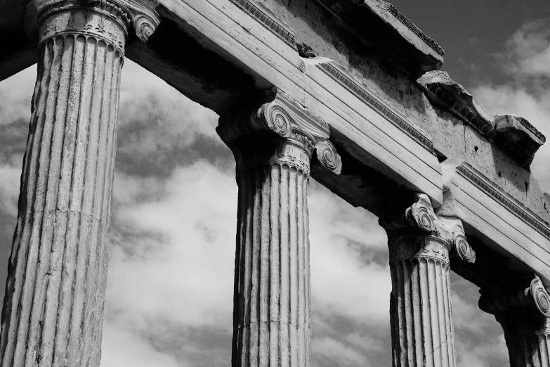 three ancient columns with very old, ornate design