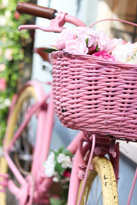 a bike has flowers in the basket and two handles