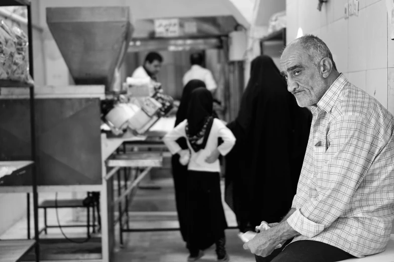 several people are waiting for food in a small room