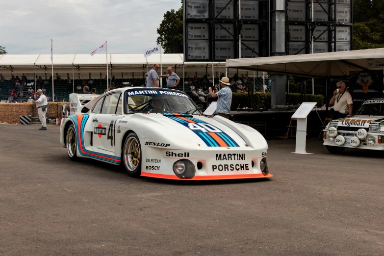 two race cars parked on top of a parking lot