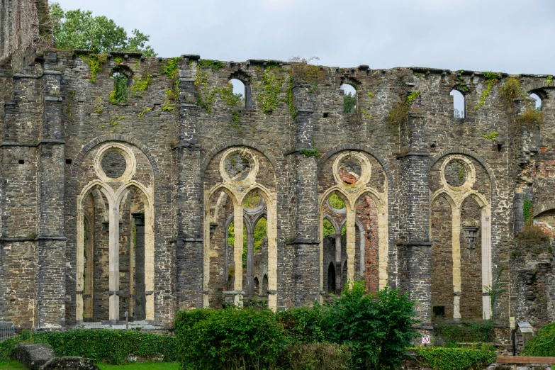 there is an old stone building that is in the field