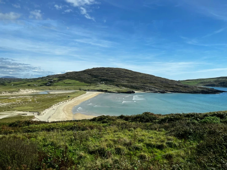 a grassy beach on an island near the ocean