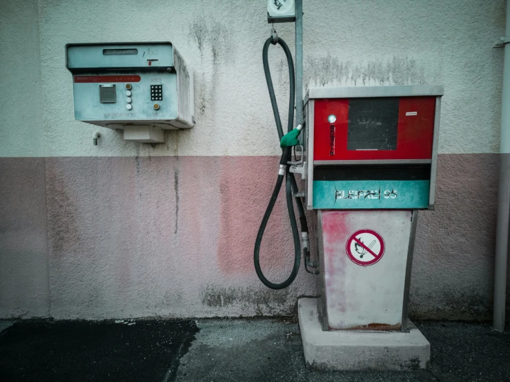 a phone booth next to a wall with no parking sign