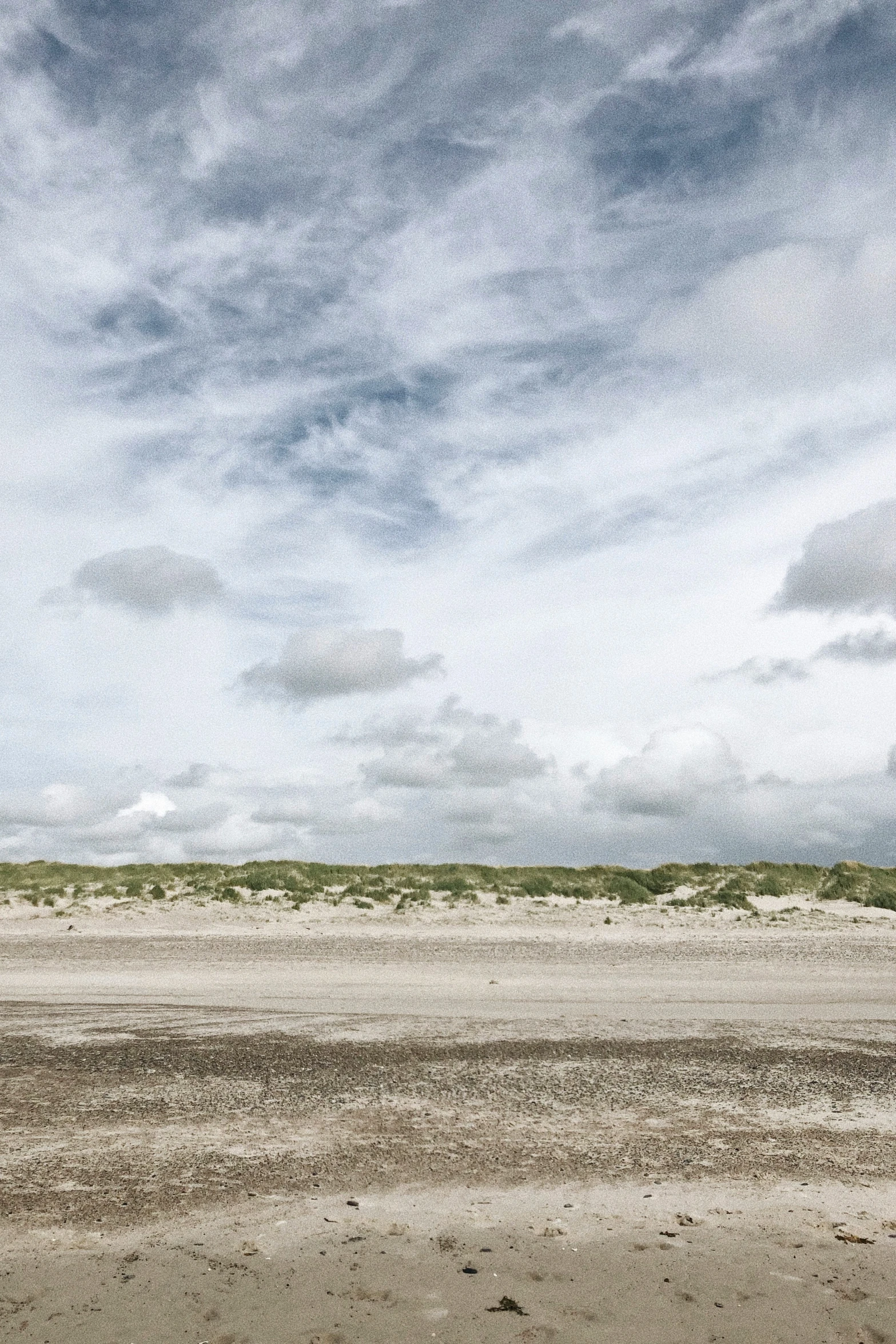 the beach on a cloudy day is empty