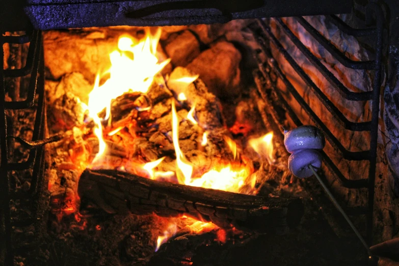 a fire burns inside an old fashioned fireplace