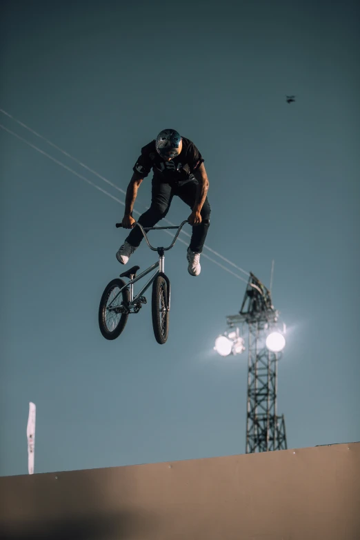 the man is jumping high on his bike