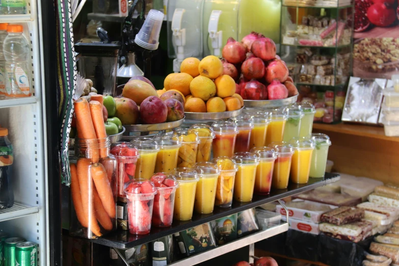 fruits and juices for sale in front of a store