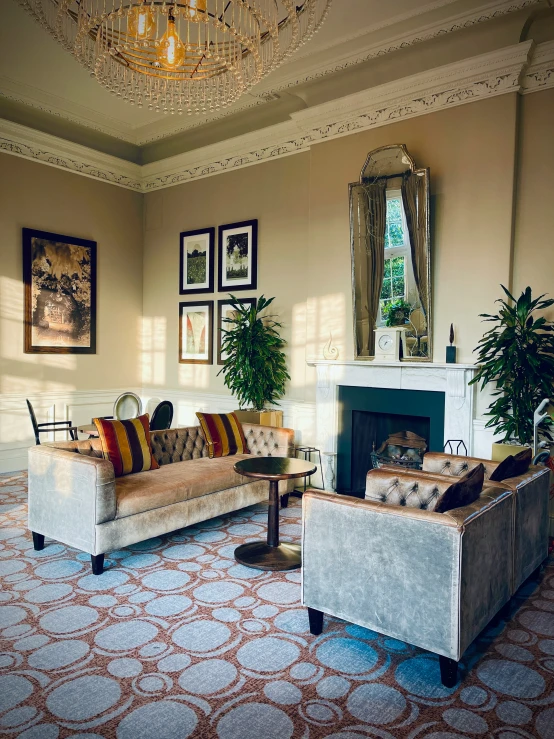 a nice living room with fancy lighting and a fireplace