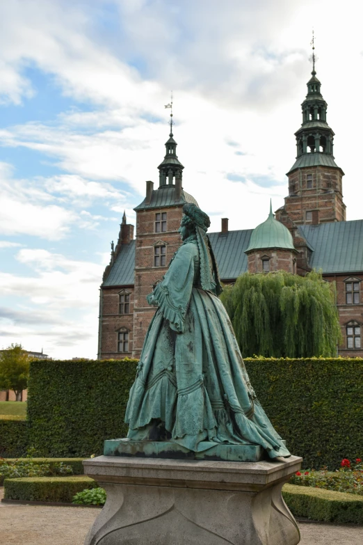 a statue in front of a building with two towers