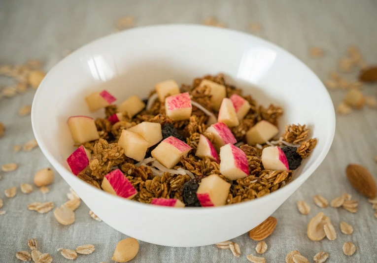 granola with fruit and nuts in a white bowl