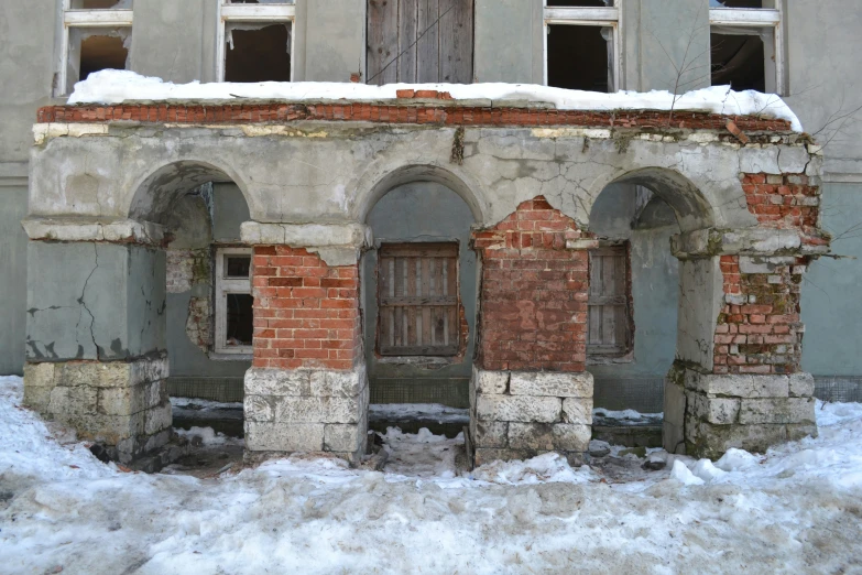 there is a old brick building with snow on it