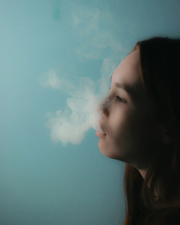 woman looking at clouds through her face with focus on her head